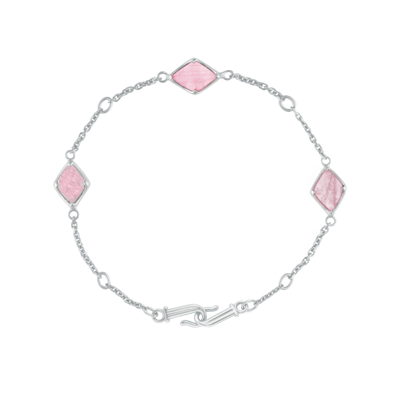 A flat-lay image of Juraster's Sterling Silver Rose Quartz Adjustable Bracelet, Three Wishes, crafted from Fairmined sterling silver and hand-cut rose quartz.