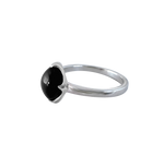 A side-view image of Juraster’s Sterling Silver Stacking Ring in Black Onyx, Lodestone, crafted from Fairmined 9ct sterling silver and a hand-cut black onyx gemstone.