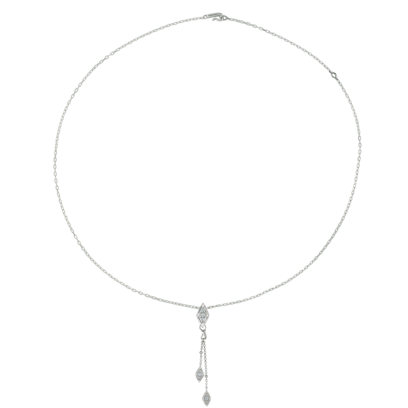 A flat-lay image of Juraster’s 9ct White Gold Diamond Tassel Pendant, Palace, crafted from Fairmined 9ct white gold and conflict-free diamonds, as a centerpiece on a silver necklace.