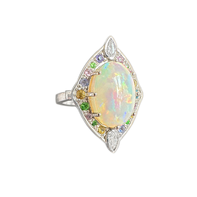 A side-view image of Juraster’s 14ct white gold transformable ring-pendant with opal, rainbow gemstones & diamonds, Selkie 2, crafted from Fairmined white gold, precious Australian opal, hand-cut gemstones and conflict-free diamonds.