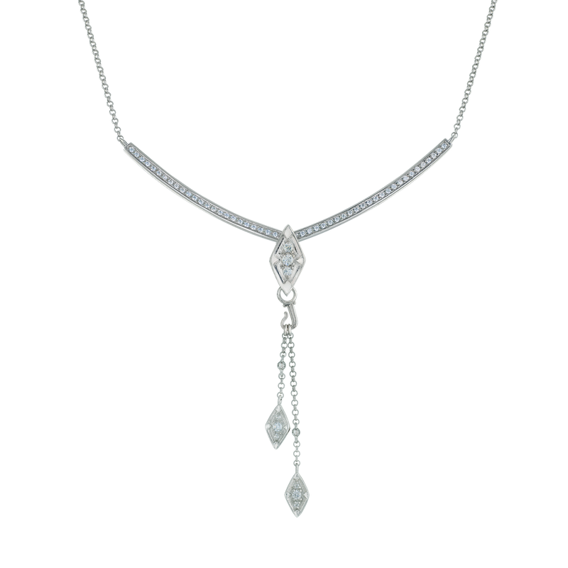 A close-up flat-lay image of Juraster’s 9ct White Gold Diamond Tassel Pendant, Palace, crafted from Fairmined 9ct white gold and conflict-free diamonds, as a centrepiece on a white gold pavé diamond necklace.