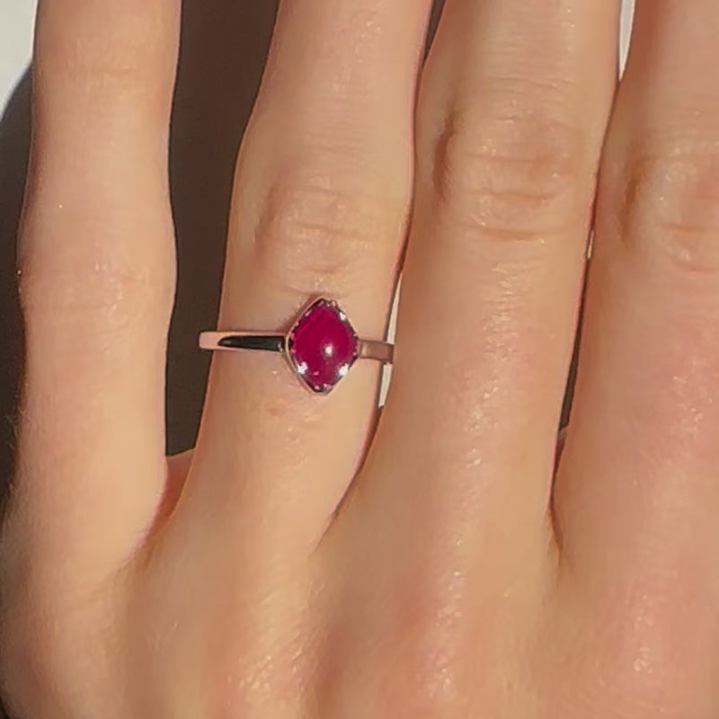 A video of a model wearing Juraster's Limited Edition Sterling Silver Stacking Ring in Red Quartz, Lodestone, crafted from Fairmined sterling silver and hand-cut red quartz.